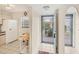 Entry to kitchen area, with a refrigerator and view of greenery outside the doorway at 175 Kings Hwy # 1014, Punta Gorda, FL 33983