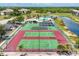 Aerial view of the tennis courts with greenery surrounding the court at 175 Kings Hwy # 1014, Punta Gorda, FL 33983