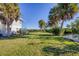 Side yard with boat and lush tropical landscaping at 13044 Via Cassia, Placida, FL 33946