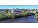 Waterfront home showcasing expansive deck and lush landscaping at 13044 Via Cassia, Placida, FL 33946