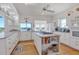 Bright kitchen features island with cooktop, ample counter space, and water views at 13044 Via Cassia, Placida, FL 33946