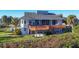 Two-story home with large deck and lush landscaping at 13044 Via Cassia, Placida, FL 33946