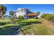 House exterior showcasing landscaping and a large deck at 13044 Via Cassia, Placida, FL 33946