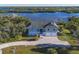 Luxury waterfront home with paver driveway, offering scenic water views at 13044 Via Cassia, Placida, FL 33946