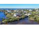 Aerial view of waterfront home with private dock and lush landscaping at 13044 Via Cassia, Placida, FL 33946