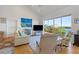 Bright living room with hardwood floors and water views at 13044 Via Cassia, Placida, FL 33946