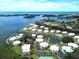Aerial view of waterfront community with tennis courts and pool at 13044 Via Cassia, Placida, FL 33946