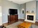 Living room with fireplace and large TV at 8 Sportsman Ter, Rotonda West, FL 33947