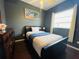 Cozy bedroom with a double bed, dresser, and large window at 8 Sportsman Ter, Rotonda West, FL 33947