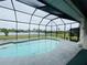 Relaxing screened pool area overlooking a tranquil lake at 8 Sportsman Ter, Rotonda West, FL 33947
