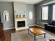 Living room with fireplace and large TV at 8 Sportsman Ter, Rotonda West, FL 33947
