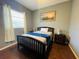 Cozy bedroom with double bed, nightstands, and ample natural light at 8 Sportsman Ter, Rotonda West, FL 33947