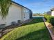 Landscaped backyard with a view of a lake and lush greenery at 8 Sportsman Ter, Rotonda West, FL 33947