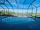 Inviting screened pool with lake view at 8 Sportsman Ter, Rotonda West, FL 33947