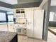 Bright kitchen with white cabinetry, stainless steel appliances, and a large refrigerator at 8 Sportsman Ter, Rotonda West, FL 33947