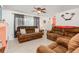 Relaxing living room with brown leather reclining sofas and light wood flooring at 1361 Newton St, Port Charlotte, FL 33952