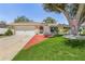 Single-story home with red walkway, garage, and mature tree at 1361 Newton St, Port Charlotte, FL 33952