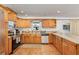 Well-equipped kitchen with light wood cabinets, stainless steel appliances, and tile flooring at 1361 Newton St, Port Charlotte, FL 33952
