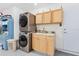 Convenient laundry room with stacked washer and dryer, and additional cabinets at 1361 Newton St, Port Charlotte, FL 33952