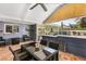 Covered patio with seating area, adjacent to pool and outdoor kitchen at 1361 Newton St, Port Charlotte, FL 33952