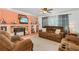Inviting living room with brown leather sofas, fireplace, and a coral accent wall at 1361 Newton St, Port Charlotte, FL 33952