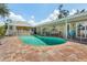 Kidney-shaped pool with brick pavers and safety fence at 1361 Newton St, Port Charlotte, FL 33952