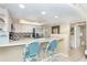 Kitchen features a breakfast bar with two blue chairs and white cabinets at 7536 Palm Island S Dr # 1511, Placida, FL 33946