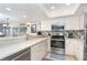 Modern kitchen with stainless steel appliances and light-colored cabinetry at 7536 Palm Island S Dr # 1511, Placida, FL 33946