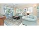 Living Room with light teal sofas and a view to a screened porch at 7536 Palm Island S Dr # 1511, Placida, FL 33946