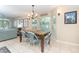 Dining area with a granite top table and blue chairs near large windows at 7536 Palm Island S Dr # 1511, Placida, FL 33946