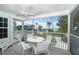 Screened porch with white table and chairs overlooking the ocean at 7536 Palm Island S Dr # 1511, Placida, FL 33946