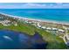 Aerial view of coastal community with beach, tennis court, and homes at 7454 Palm Island Dr # 3313, Placida, FL 33946