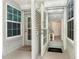 Open door revealing tiled foyer with a small table and beachy decor at 7454 Palm Island Dr # 3313, Placida, FL 33946