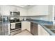 Well-equipped kitchen with stainless steel appliances and white cabinets at 7454 Palm Island Dr # 3313, Placida, FL 33946