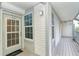 Exterior condo entry with a gray door, light gray siding, and wood flooring at 7454 Palm Island Dr # 3313, Placida, FL 33946