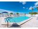 Community pool with plenty of lounge chairs and umbrellas at 7454 Palm Island Dr # 3313, Placida, FL 33946