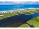 Aerial view of coastal community with beach, waterway, and upscale homes at 7454 Palm Island Dr # 3313, Placida, FL 33946