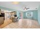 Open kitchen and dining area with light teal walls and tile floors at 3081 Pellam Blvd, Port Charlotte, FL 33948