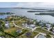 Picturesque aerial view of a coastal community featuring unique homes, lush landscaping, and waterfront access at 342 Green Dolphin Dr, Placida, FL 33946