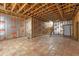 Unfinished basement with insulation, wood rafters, and stairs to the upper level at 342 Green Dolphin Dr, Placida, FL 33946