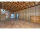 Unfinished basement with insulation, wood rafters, stairs, and access to other rooms at 342 Green Dolphin Dr, Placida, FL 33946
