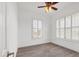 Light bedroom featuring dark-wood look tile flooring, plantation shutters and white walls at 342 Green Dolphin Dr, Placida, FL 33946