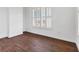 Bedroom with dark-wood look tile flooring, white walls, natural light and white trim at 342 Green Dolphin Dr, Placida, FL 33946