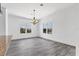 Open dining room features wood-look tile flooring, bright natural light, and modern lighting at 342 Green Dolphin Dr, Placida, FL 33946