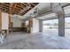 Open garage with an overhead door, utility sink, and work bench space at 342 Green Dolphin Dr, Placida, FL 33946