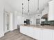 Bright kitchen boasts a large island, white cabinetry, stainless steel appliances, and tile floors at 342 Green Dolphin Dr, Placida, FL 33946