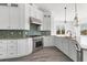 Charming kitchen featuring white cabinetry, stainless steel appliances, decorative tile backsplash, and counter space at 342 Green Dolphin Dr, Placida, FL 33946