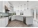 Bright kitchen with white cabinetry, stainless steel appliances, and stylish pendant lighting, ample counter space at 342 Green Dolphin Dr, Placida, FL 33946