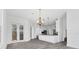 Bright open living space features wood-look tile flooring, modern lighting, and seamless flow to kitchen at 342 Green Dolphin Dr, Placida, FL 33946