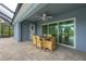 Covered patio with table and chairs, adjacent to refreshing pool at 8099 Walbert St, Port Charlotte, FL 33981